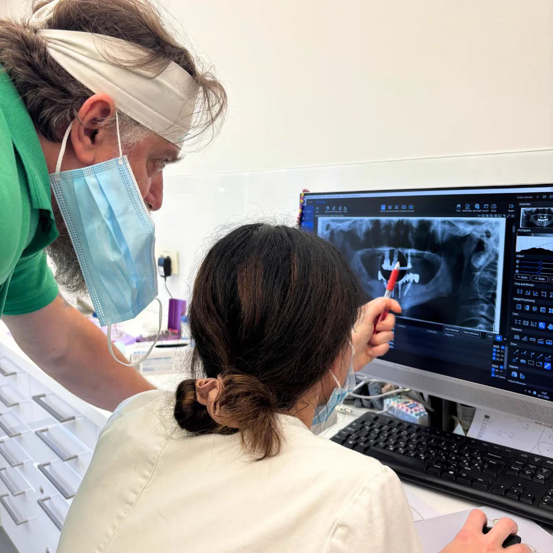 Two specialists reviewing a panoramic X-ray during treatment planning in Zagreb