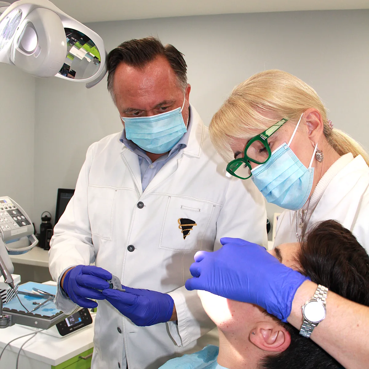 Two specialists examining a patient together